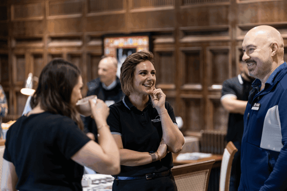 Active Digital team members engaging at a networking event in a wooden venue.