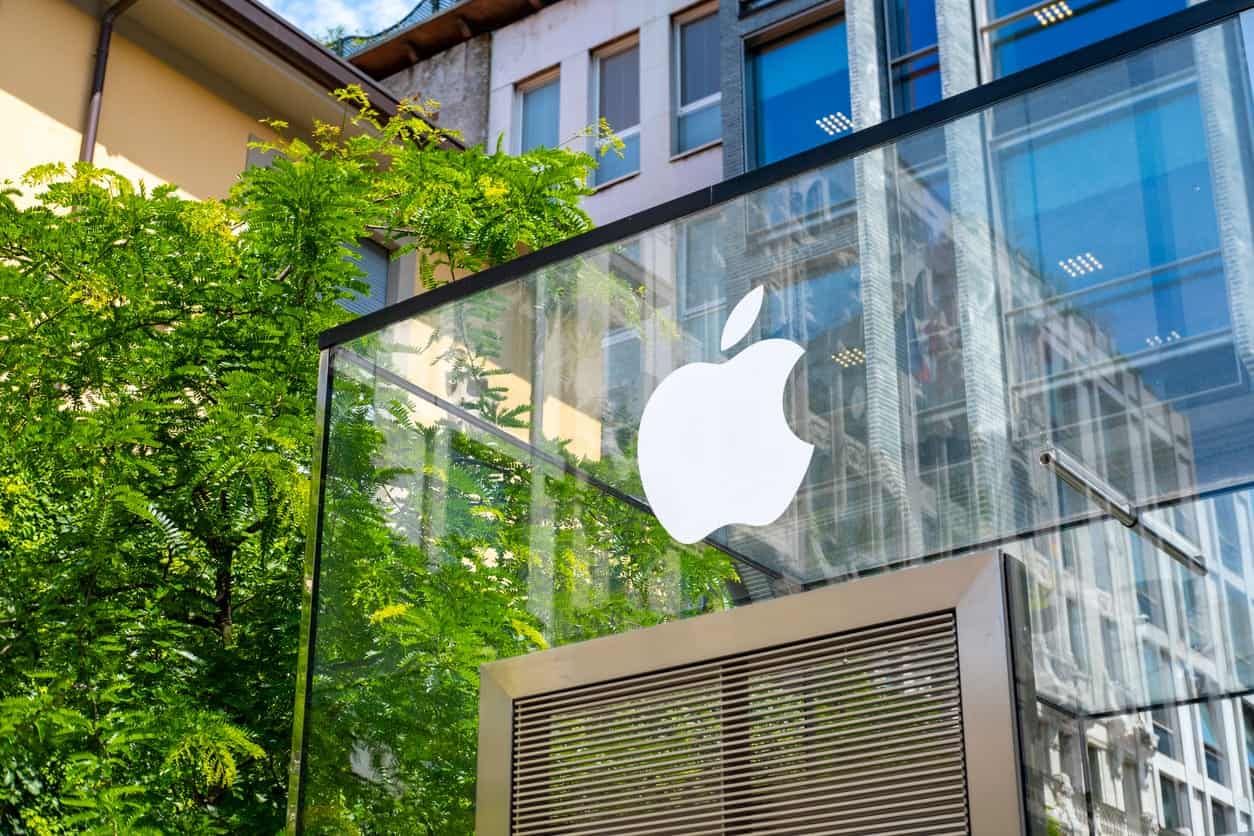 Apple store exterior with glass facade and greenery in London.