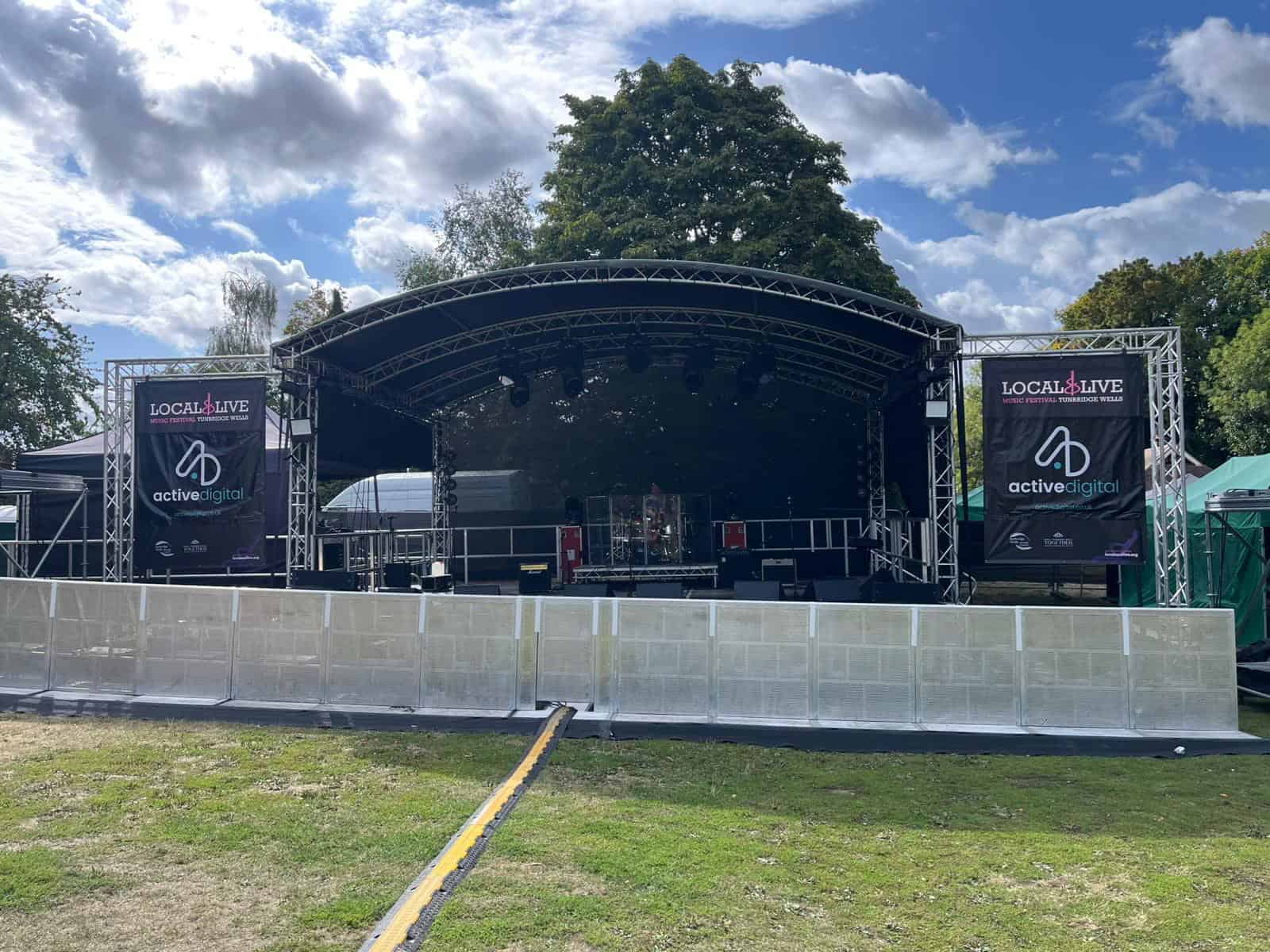 Large outdoor stage with banners for Local & Live 2026 and Active Digital.